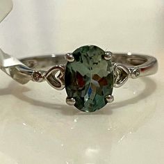 a ring with a green stone in it