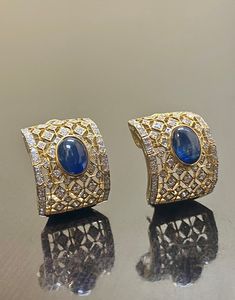 DeKara Designs Collection Metal- 18K White Gold, .750. 15.50 Grams. Stones- 2 Genuine Cabochon Oval Ceylon Blue Sapphires 5.02 Carats, 168 Round Diamonds F-G Color SI2 Clarity 2 Carats. One of a kind entirely handmade, Art Deco 18K Yellow Gold Sri Lanka Ceylon Cabochon Cut Blue Sapphire and Pave Set Diamond Art Deco Inspired One of a Kind Earrings. Each earring has an amazing oval cabochon blue sapphire that is professionally and uniquely bezel/burnish set. There are 79 round pave set diamonds o Luxury Oval Cabochon Gemstone Earrings, Elegant Blue Hand Set Earrings, Luxury Oval Sapphire Earrings, Blue Diamond Earrings With Elegant Design, Luxury Blue Sapphire Earrings, Luxury Blue Hallmarked Earrings, Blue Oval Hallmarked Earrings, Elegant Blue Oval Cabochon Earrings, Traditional Oval Earrings For Formal Occasions