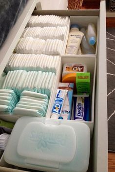 an organized drawer with toothbrushes, soaps and other hygiene products in it