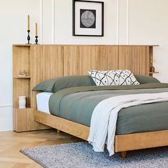 a bed sitting in a bedroom next to a wooden book shelf on top of a hard wood floor