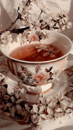 a tea cup with some flowers in it