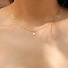 Show your love for pearls every single day with this delicate & gorgeous pearl necklace that features a durable gold chain and a freshwater pearl with high luster. Dainty Gold-plated Charm Necklace With Pearl Pendant, Simple Gold Jewelry With Pearl Pendant, Gold Pearl Charm Necklace With Delicate Chain, Delicate Gold Pearl Necklace With Clavicle Chain, Simple Pearl Necklace With Clavicle Chain As Gift, Gold Dainty Pearl Drop Necklace, Dainty Gold Pearl Necklace With Pearl Drop, Dainty Gold Pearl Drop Necklace, Simple Pearl Clavicle Chain Necklace As Gift