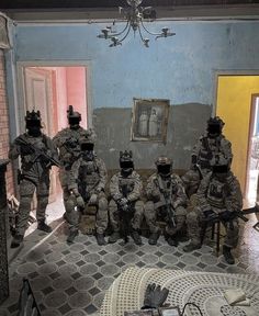 some soldiers are sitting in the middle of a room