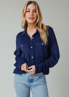 The perfect button up for the season ahead! This super soft button up shirt will be a versatile addition to your wardrobe to dress up or down.  Navy super soft button up top Long sleeves Two front pockets at the bust Button closure on the front Designed in the U.S.A. Produced in China. Model is wearing a size small  75% Rayon / 15% Acrylic / 10% Spandex SIZE CHART S: Bust: 40" / Length: 24.5" M: Bust: 42" / Length: 25.5" L: Bust: 44" / Length: 26.5" XL: Bust: 46" / Length: 27.5" Button Ups, Blouse Tank Top, Button Up Top, Long Jumpsuits, Sweaters Crewneck, Vintage Sweatshirt, Size Charts, Vintage Tees, Button Up Shirt