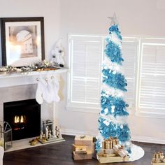 a blue and white christmas tree in a living room