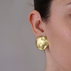 "These earrings will be a gorgeous, understated compliment to your everyday fashion silhouette, but they also know how to shine on a big night out. Our large, hammered shell discs clip on firmly but never pinch. Since they're light you may even forget you have them on, but others will always remember how sensational you look. PRODUCT DETAILS: Materials: Pewter casting with either 24 kt gold plating / Sterling silver plating / Rose gold plating. Measurements: 1\" wide Earring closure: Clip on Lig Elegant Hand Cast Metal Earrings, Elegant Hand Cast Jewelry For Parties, Modern Matte Gold Hammered Jewelry, Elegant Hand-cast Jewelry, Hammered Metal Jewelry For Formal Occasions, Formal Hammered Metal Jewelry, Elegant Formal Jewelry With Hand Cast, Elegant Hand Cast Jewelry For Formal Events, Formal Hand Cast Jewelry