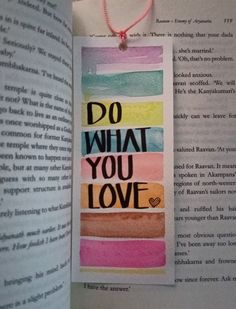 an open book with a tag that says do what you love on it and the words do what you love written in cursive