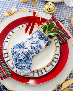 a blue and white plate topped with a christmas stocking next to a red napkin