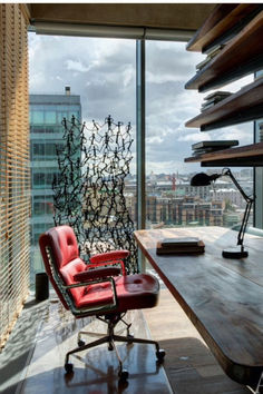 a red chair sitting in front of a wooden table