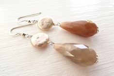 "Drop earrings with faceted beige sunstone and freshwater pink pearls. LENGTH: 2.6 inches - 6,5 cm - 6,4 gr. each MATERIALS: 925 Sterling Silver Sunstone: it is linked to luck and good fortune. Sunstone instills good nature, heightens intuition and allows the real self to shine . It alleviates stress and increases vitality. Encourages independence and originality. Sunstone facilitates self-empowerment and independence. It acts as an antidepressant. Increases self worth and confidence. Encourages Elegant Sterling Silver Earrings With Natural Stones, Silver Pearl Earrings With Natural Stones, Sterling Silver Faceted Earrings For Wedding, Elegant Sterling Silver Pearl Earrings With Natural Stones, Faceted Sterling Silver Earrings For Wedding, Elegant Silver Earrings With Natural Stones, Elegant Silver Pearl Earrings With Natural Stones, Elegant Nickel-free Briolette Earrings, Wedding Sterling Silver Faceted Earrings