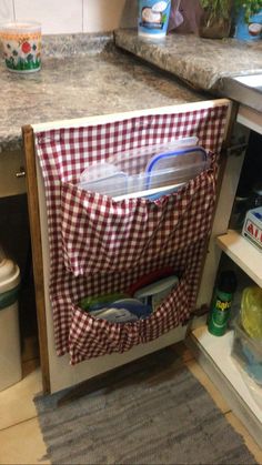 an open refrigerator door in a kitchen next to a sink