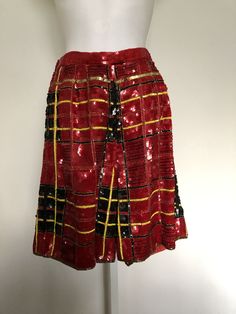 Amazing vintage two piece Modi sequins jacket and shorts. Festive and fun this set is perfect for the holiday season! The jacket has a full placket of buttons. The shorts are mid thigh length with a zipper and hook eye closure at the back as well as an elastic waist. Buffalo plaid with a hint of yellow. Silk, lined in rayon. Both marked size medium 8-10 C. 1980's-1990's. Jacket Measurements: Shoulder seam to shoulder seam: 19 inches, ample built in shoulder pads Length: 19 inches The following m Retro Red Party Bottoms, Vintage Red Bottoms For Party, Fitted Multicolor Sequin Sets, Luxury Multicolor Sequined Sets, Multicolor Sequined Crop Top, Vintage Reworked Plaid Tops, Vintage Fitted Sequin Outerwear, Vintage Romper, Sequin Jacket