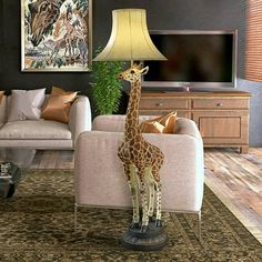 a giraffe standing in front of a lamp on a table next to a couch