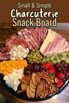 a platter with cheeses, crackers and fruit is shown on a table