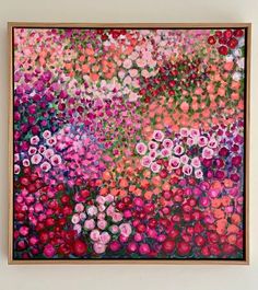 an abstract painting with pink, red and purple flowers on it's surface in a wooden frame