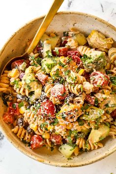 a bowl filled with pasta salad on top of a table