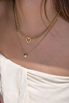 Meet Tia—your new favorite statement piece. With a chunky chain and adorable heart-shaped clasp, this necklace is perfect for adding your favorite charms. It’s the kind of piece that effortlessly adds a fun, stylish twist to any look. Heart clasp chain necklace; charms available for additional purchase 14k gold plated with brass base Protective coating, water resistant 17" chain, 2.5" thick Heart clasp measures approximately 16mm by 15.5mm Fits these clasps: Soleil, Frankie Chunky Chain Charm Necklace Gift, Trendy Heart Charm Pendant Necklace, Trendy Heart Pendant Jewelry With Adjustable Chain, Chic Heart Pendant Clavicle Chain, Chic Heart Pendant Clavicle Chain Jewelry, Chic Heart Pendant On Short Chain Jewelry, Trendy Open Heart Jewelry For Everyday, Trendy Heart Pendant Charm Necklace With Chain, Trendy Necklaces For Valentine's Day