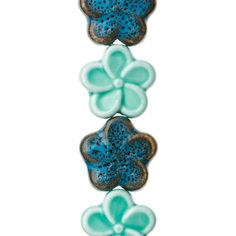 three blue and green flower beads on a white background