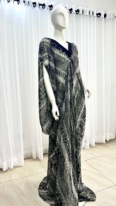 This Silk Kaftan maxi dress is made with Polysilk and Lace Front. It can be styled in different ways, you can dress it up with high heels or dress down with flats/sneakers. The Hand can be worn in 2 ways. one way shows off the arm, the 2nd way has the arm covered for modesty. Notice the slits.Other prints are also available, kindly start a conversation to ask for more information and pics.Contact us for custom looks and more style options. Sizing 🌺 Your height or desired kaftan length is needed Elegant Backless Maxi Dress For Vacation, Casual Chiffon Floor-length Maxi Dress, Black Silk Full Length Dress, Elegant Draped Dress For Vacation, Fitted Rayon Maxi Dress For Night Out, Flowy Asymmetrical Maxi Dress For Party, Casual Floor-length Maxi Dress For Party, Fitted Kaftan For Evening In Summer, Fitted Kaftan For Summer Evening