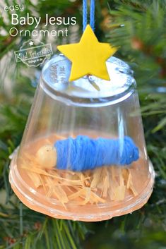 an ornament hanging from a christmas tree with a blue thread wrapped around it