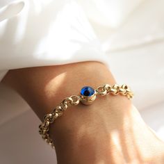 14K Gold Evil Eye Rolo Chain Bracelet Materials & Specifications:  - 14k gold rolo chain bracelet - Lobster clasp closure - Chain thickness is about 6.8mm - Chain links are hollow - Available in 1, 2 or 3 evil eye charm options - The dimensions of a single evil eye charm are 10.35mm x 11.75mm - The dimensions of 2 and 3 evil eye charms are 10.07mm x 10.77mm Available in 4 different chain lengths: 6.7in (17cm), 7in (18cm), 7.5in (19cm), and 7.9in (20cm) As with all of our pieces, this item is han Charm Bracelet With Solid Links As A Gift, 14k Gold Chain Bracelet With Birthstone, Yellow Gold Birthstone Chain Bracelet, Minimalist Gold Chain Bracelet With Birthstone, Gold Round Bracelet With Birthstone, Formal Gold Bracelets With Birthstone, Round Rolo Chain Charm Bracelet As Gift, Metal Bracelets With Rolo Chain As Gift, Metal Bracelets With Rolo Chain For Gift