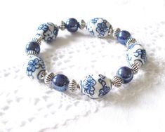 Beautiful delft blue style stretch bracelet with delft blue style hand painted porcelain beads, silver tone metal beads and strong elastic. Maximum wrist size  approximately 16.5 cm. (± 6.5 inches). For more jewelry please visit our shop: http://www.minouc.etsy.com Blue And White Bracelet, Porcelain Beads, White Bracelet, Delft Blue, White Bracelets, Jewelry Blue, Painted Porcelain, Blue Style, Blue Jewelry