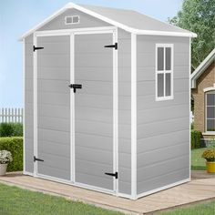 a large gray shed sitting on top of a wooden deck