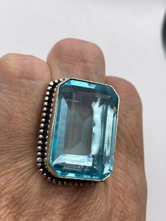 Vintage Aquamarine vintage Art Glass Deco ring  Large brilliant aqua antique glass  Ornate German Silver Vintage ring, does not tarnish Size 8 My jeweler will re size for a $20 fee  All rings are shipped in a nice gift box.   Check out our over a THOUSAND great reviews Engraving is $4 per letter and is not always perfect depending on the piece. It can take a few days if the jeweler is busy. This is payable to Paypal Judithsltd@gmail.com Rectangular Aquamarine Ring For Gift, Vintage Aquamarine Silver Rings, Vintage Aquamarine Gemstone Jewelry, Rectangular Aquamarine Silver Ring, Vintage Aquamarine Topaz Ring Gift, Vintage Aquamarine Jewelry For Gift, Vintage Faceted Rings As Gift, Vintage Faceted Rings For Gift, Vintage Blue Topaz Rings As Gift