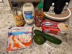 the ingredients to make this dish are laid out on the counter top, including cucumbers, mayonnaise, and other items