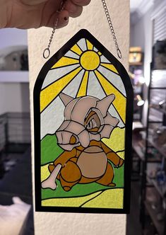 a stained glass window hanging from a chain