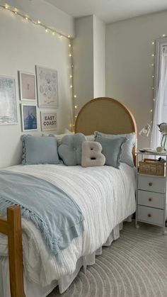 a bedroom with a bed, dresser and pictures on the wall above it's headboard