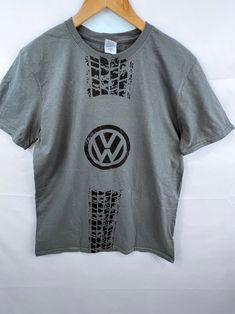 This genuine licensed Volkswagen t-shirt is new and in original condition with tag. This comes from an archive of shirts that were collected and stored by the dealer.  This shirt is retired/out of production and is no longer manufactured or available through Volkswagen or its vendor partners. Quantities are limited to those on hand and no more will be available when they are sold out. RETURNS & EXCHANGES are accepted within 7 days of delivery and are only for manufacturer defects on the product. Volkswgen Shirt, Knit Hat With Brim, Gt Logo, Tshirt Graphics, Smiley Face Shirt, Couple Tshirts, Volkswagen Beetle, Tshirt Design, Tshirt Logo