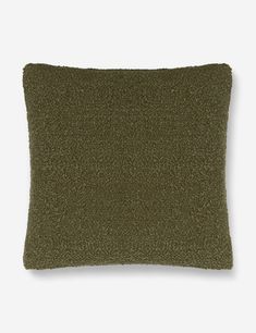 an olive green pillow on a white background, with a small square pattern in the middle