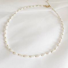 Genuine AA freshwater rice pearls & high quality 14k gold filled beads and finishes; adjustable. Length: 16” + 2” gold filled extender Genuine 3-4mm freshwater pearls Lobster clasp Each natural pearl is unique and therefore no two are alike. Pearl, colors and sizes may vary. Handmade with the highest standards & quality materials. * PEARL CARE TIPS Here's what we recommend: 1) Always keep pearls safe as they can scratch easily 2) Avoid water and chemicals as they can eat away the nacre of the pe Pearls Colors, Rice Pearls, Cotton Jewelry, Pearl Beaded Necklace, Stone Harbor, Stacked Earrings, Gold Bond, Pearl Collection, Meaningful Jewelry