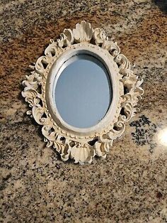 a round mirror sitting on top of a counter