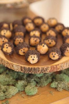 some little brown bears sitting on top of a wooden plate