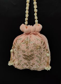 Potli hand-embroidered with Antique Golden beads in on both sides. The Potli comes with beautiful handmade Latkans and a handmade beaded handle. Indian Wedding Giveaways, Embroidered Handbag, Potli Bags, Bag Elegant, Handcrafted Bags, Velvet Choker, Modern Embroidery, Pine Needles, Women Artisans