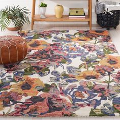 an area rug with flowers on it in a living room next to a book shelf