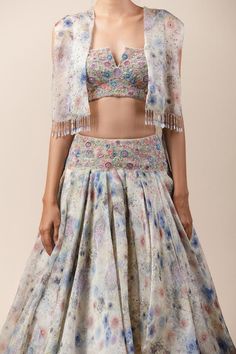 Multi-color printed layered lehenga paired with resham-badla worked cropped bustier-blouse. Comes with crystal tassel cape.
Component: 3
Embroidered, Printed
Fabric: Sheer Silk, Tulle
Color: Multi Color
Crystal tassels
Layered lehenga
Front open cape - Aza Fashions Cape Lehenga, Printed Lehenga, Mehendi Outfits, 1950’s Fashion, Black Floral Top, Lehenga Collection, Saree Blouse Designs Latest, Silk Tulle, Tarun Tahiliani