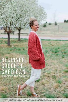 a woman is walking in the grass wearing a red sweater and white pants