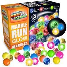 marbles are in front of a box with the words marble run glow on it