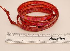 Red, red, red iridescent Tila tile beads and 1.5mm metallic red leather cord make up this multi-wrap bracelet. Length can be adjusted. It's easy to cut off excess leather and knots. Closure is beautiful domed and faceted flower-shaped red button. Knotted leather loops. Designed and created by TLP of Takeen Arts. Item B485. Red Wrap Bracelet With Round Beads, Red Hand Wrapped Wrap Bracelet With Round Beads, Red Adjustable Bohemian Wrap Bracelet, Red Adjustable Wire Wrapped Bracelets, Adjustable Red Wire Wrapped Bracelets, Adjustable Red Wire Wrapped Bracelet, Handmade Adjustable Red Wrap Bracelet, Red Wrap Bracelet With Round Beads For Gift, Adjustable Red Handmade Wrap Bracelet