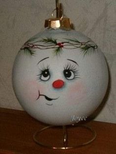 a glass ornament with a face painted on it