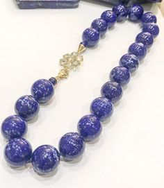 Beautiful, large polished beads of Lapis Lazuli from Afghanistan, knotted on silk and finished on a handmade 925 silver and gold plated flower clasp set with faceted blue topaz. Measuring approximately 20" in length and weighs 0.274kgs.All jewellery is packed in beautiful gift pouches.The item will be securely packaged and sent promptly after payment is received. Please note if you require a quicker method of delivery we can also arrange that.Thank you so much for looking at my shop!Please conta Smoky Quartz Necklace, Blue Topaz Necklace, Topaz Necklace, Baroque Pearl Necklace, Rose Earrings, Quartz Necklace, Fine Jewellery, Silver And Gold, Earings Piercings