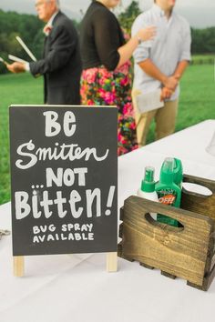 a sign that says be smitten, not bitten by a lawn mower