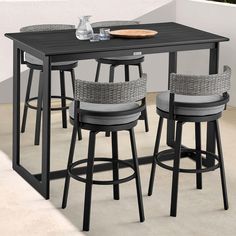 a table with four stools and a plate on it