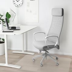 an office chair sitting in front of a white desk