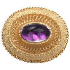 A fine and impressive antique Victorian paste and 15 karat yellow gold brooch; part of our antique jewelry and estate jewelry collections. This impressive antique Victorian brooch has been crafted in 15k yellow gold. The antique gold brooch displays a bezel set paste cabochon foil* in relief within an oval 15k yellow gold frame. The feature imitation amethyst is encircled by an applied rope twist decorated border. The oval frame is ornamented with applied rope twist decorated semi-circular motif Brooch Display, Evening Jewelry, Rope Twist, Gold Brooch, Antique Brooches, Victorian Gold, Gold Brooches, Oval Frame, Victorian Jewelry