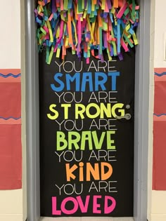 a door decorated with colorful streamers and the words you are smart, strong, strong, strong, brave, kind of kind of love