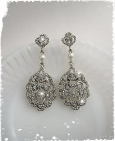 "Art Deco - The Great Gatsby, Downton Abbey inspired crystal peacock fan long earrings. Beautiful and very sparkling dangle chandelier earrings are made of brilliant Clear Austrian Crystals in 18K gold plated alloy settings with Swarovski Pearl (photo No.1 & 2 shown in \"White gold plated\" with Swarovski \"White\" pearl). Photo No.3 \"Champagne gold\" is yellow gold has peach hue (between yellow and rose gold). Please note that product colors in photos may appear slightly different on vario Ornate Silver Chandelier Earrings For Wedding, Exquisite Jeweled Earrings For Wedding, Elegant Jeweled Crystal Earrings For Wedding, Ornate Pearl Drop Bridal Earrings For Wedding, Ornate Teardrop Chandelier Earrings For Wedding, Ornate Pearl Drop Bridal Earrings, Vintage Crystal Chandelier Earrings For Wedding, Elegant Jeweled Pearl Wedding Earrings, Jeweled Chandelier Drop Earrings For Wedding